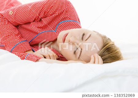 Woman sleeping in bed on the side Woman sleeping in bed on the side 138352069