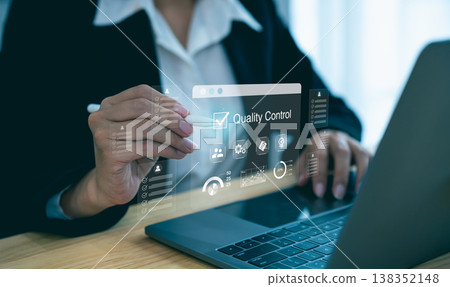 Professional woman engaging in quality control task with holographic interface and laptop, showcasing modern technology and business efficiency Professional woman engaging in quality control task with holographic interface and laptop, showcasing modern technology and business efficiency 138352148