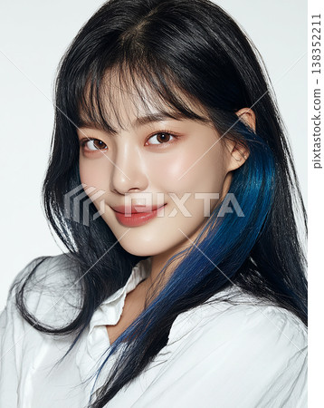 A young woman with long black hair turns around and smiles. 138352211