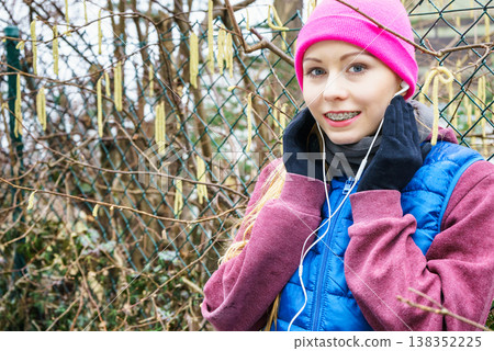 Woman wearing sportswear exercising outside during autumn 138352225
