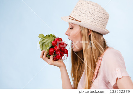 Happy woman holding radish Happy woman holding radish 138352279