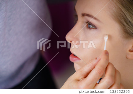 Woman getting make up done by artist Woman getting make up done by artist 138352295