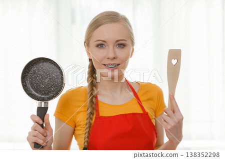 Woman holding cooking pan and spatula 138352298