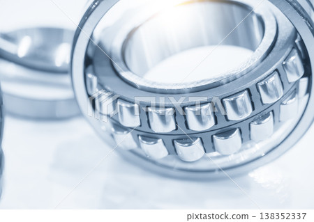 Close-up of a disassembled cylindrical roller bearing showing the inner structure, rolling elements, and precision rings. Close-up of a disassembled cylindrical roller bearing showing the inner structure, rolling elements, and precision rings. 138352337