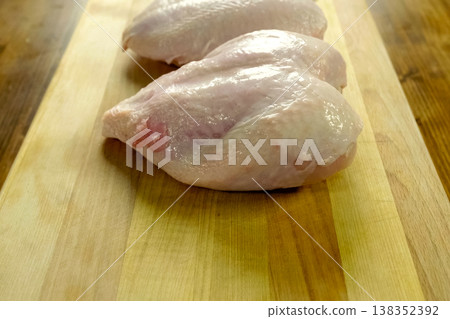 Broiler breast, chicken meat on cutting board Broiler breast, chicken meat on cutting board 138352392