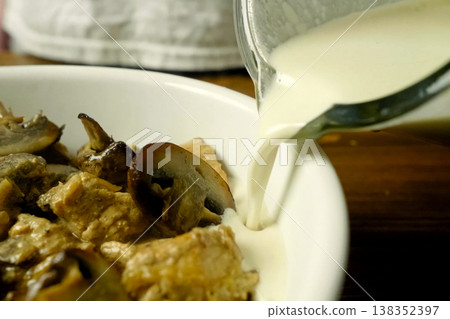 Fried pieces of chicken with mushrooms, in milk in a cup Fried pieces of chicken with mushrooms, in milk in a cup 138352397
