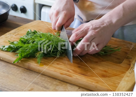 Sliced parsley and dill on board. Greens for the second course. Sliced parsley and dill on board. Greens for the second course. 138352427