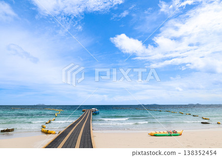 A beach and floating pier under a clear blue sky A beach and floating pier under a clear blue sky 138352454