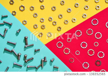 Colorful geometric hardware layout with nuts bolts and washers 138352565