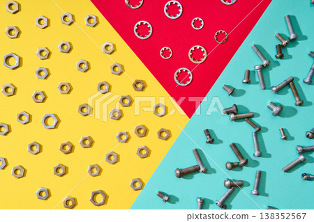 Colorful geometric hardware layout with nuts bolts and washers 138352567