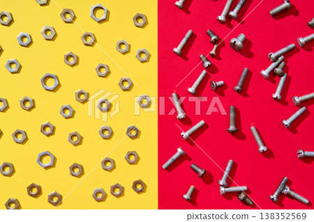 Diagonal split metal hardware composition on red yellow background Diagonal split metal hardware composition on red yellow background 138352569