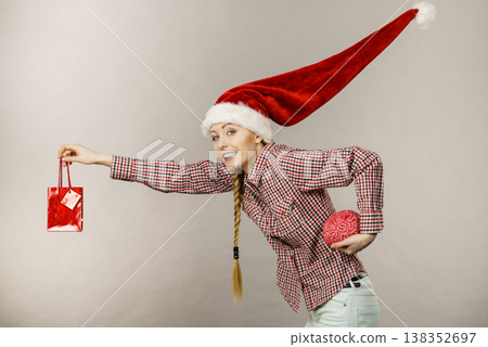 Christmas woman holding shopping bag and brain Christmas woman holding shopping bag and brain 138352697