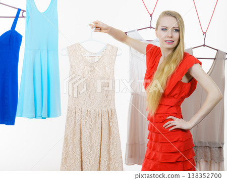 Woman choosing clothes in shop Woman choosing clothes in shop 138352700