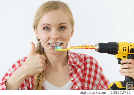 Woman burshing her teeth using drill 138352721