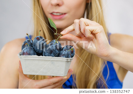 Girl holds plum fruits Girl holds plum fruits 138352747