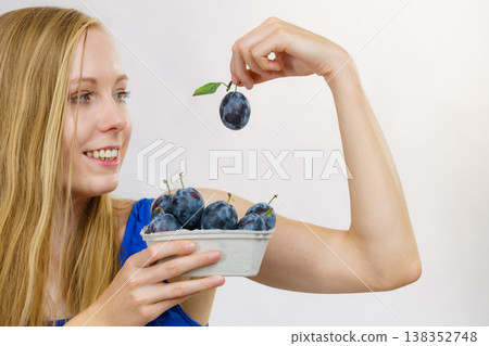 Girl holds plum fruits Girl holds plum fruits 138352748