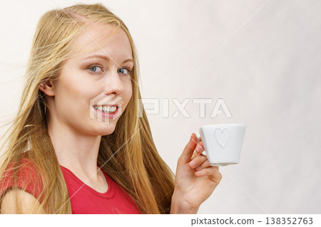Blonde girl with coffee cup Blonde girl with coffee cup 138352763