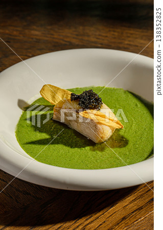 Fish fillet with green sauce and caviar garnish 138352825