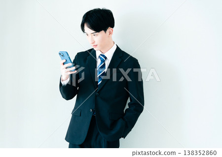 A young businessman looking at a smartphone in the office 138352860