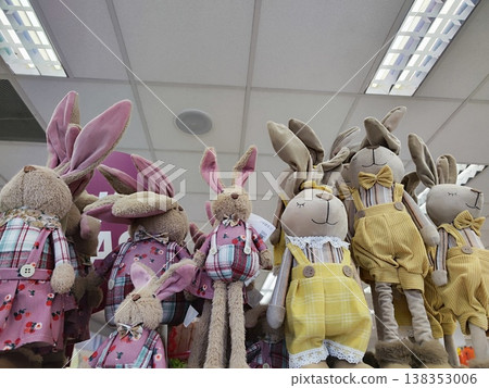 Soft rabbit toys with floppy ears are dressed in colorful outfits. Easter bunny Soft rabbit toys with floppy ears are dressed in colorful outfits. Easter bunny 138353006