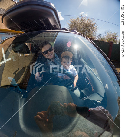 Father and son in car ready for road trip on sunny day Father and son in car ready for road trip on sunny day 138353402