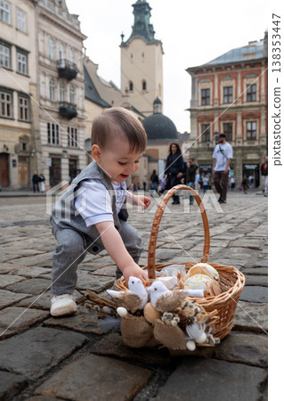 Toddler with easter basket in historic city square Toddler with easter basket in historic city square 138353447