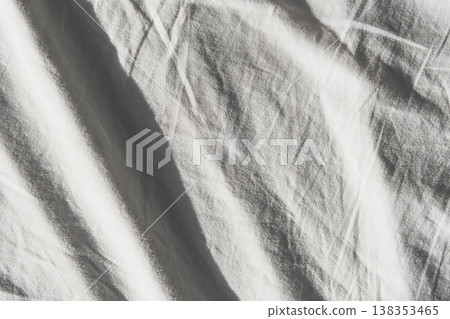 White fabric surface showing soft folds and wrinkles with natural light White fabric surface showing soft folds and wrinkles with natural light 138353465