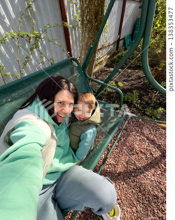 Mother and toddler selfie on garden swing bench Mother and toddler selfie on garden swing bench 138353477