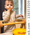 Toddler self-feeding messy meal in high chair 138353509