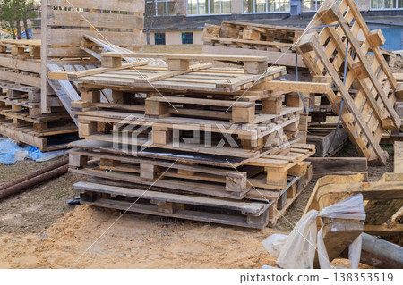 Stack of old wooden pallets at a construction site Stack of old wooden pallets at a construction site 138353519