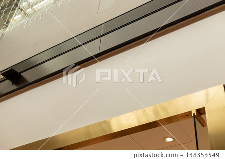 A modern storefront presents an empty space where a logo can be placed. The shop is located in a busy retail area, ready for branding and advertising opportunities 138353549