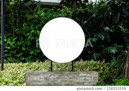 Modern storefront displays a large empty sign meant for branding. Surrounding greenery adds life to the scene. This is a location ready for a business identity 138353559