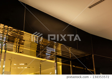 Storefront in a retail area shows an empty space where a logo can be placed. The design features clean lines and a light color scheme. Ideal for various brands and shops Storefront in a retail area shows an empty space where a logo can be placed. The design features clean lines and a light color scheme. Ideal for various brands and shops 138353572