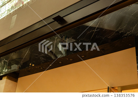 Storefront displays a clean facade with a blank area where a logo can be placed. It is designed for retail businesses. The shop is well lit and provides space for advertising Storefront displays a clean facade with a blank area where a logo can be placed. It is designed for retail businesses. The shop is well lit and provides space for advertising 138353576