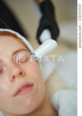 Close-up of facial treatment session at a spa with a skincare device Close-up of facial treatment session at a spa with a skincare device 138353587