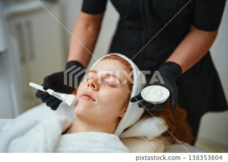 Woman receiving facial treatment at spa with soothing cream application Woman receiving facial treatment at spa with soothing cream application 138353604