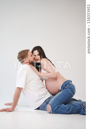 Couple enjoying intimate moment during pregnancy in studio Couple enjoying intimate moment during pregnancy in studio 138353951