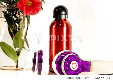 Red bottle and headphones with a flower Red bottle and headphones with a flower 138353993