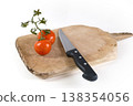 Preparing to slice fresh tomatoes on a wooden chopping board 138354056