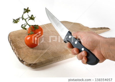 Preparing to slice fresh tomatoes on a wooden chopping board 138354057