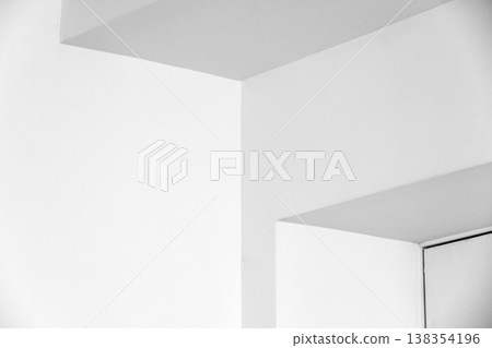 Minimal white interior corner showcasing clean geometric lines, soft shadows Minimal white interior corner showcasing clean geometric lines, soft shadows 138354196