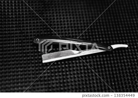 An Antique Grooming Scene With Sharpened Razor On Textured Mat And Leather Strop In Soft Lighting Atmosphere 138354449