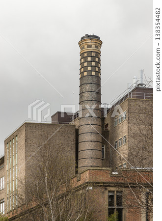 The Boiler House at Newcastle University is defined by its towering industrial chimney, which rises prominently above the surrounding weathered masonry. This historic structure once served as the home The Boiler House at Newcastle University is defined by its towering industrial chimney, which rises prominently above the surrounding weathered masonry. This historic structure once served as the home 138354482