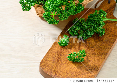 Vibrantly green parsley placed on a wooden board Vibrantly green parsley placed on a wooden board 138354547