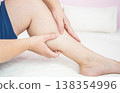 Woman with muscle pain or leg pain, massaging her leg. 138354996