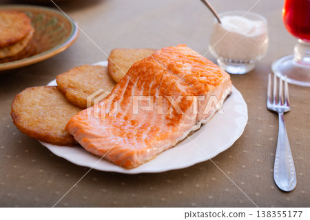 Seared Trout and Draniki on White Plate 138355177