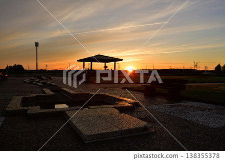 The setting sun illuminates the square. 138355378