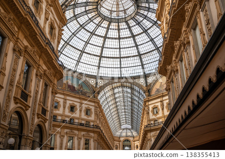 Iconic glass dome and elegant neo renaissance architecture defining the historic galleria vittorio emanuele ii, a renowned shopping gallery and tourist attraction in milan 138355413