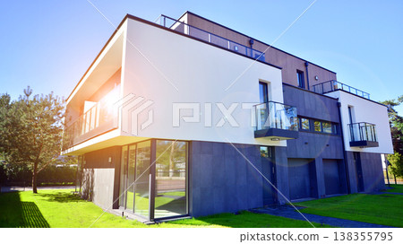 Terraced family homes in newly developed housing estate. The real estate market in the suburbs. New single family houses in a new development area. Residential homes with modern facade.  138355795