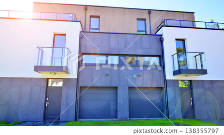 Terraced family homes in newly developed housing estate. The real estate market in the suburbs. New single family houses in a new development area. Residential homes with modern facade.  138355797